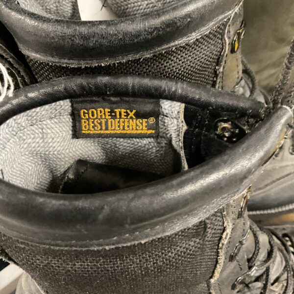 Close-up of vintage leather hiking boots showing wear and detail.