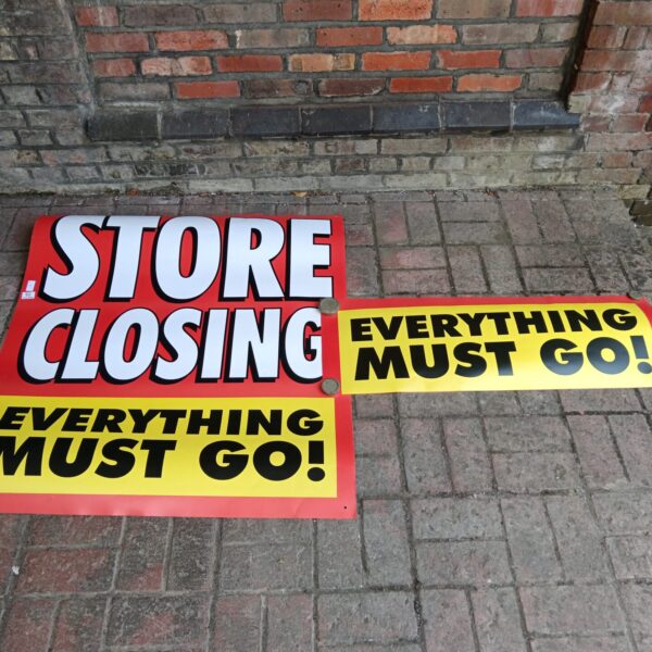 Two vibrant store closing sale signs announcing a store closure.