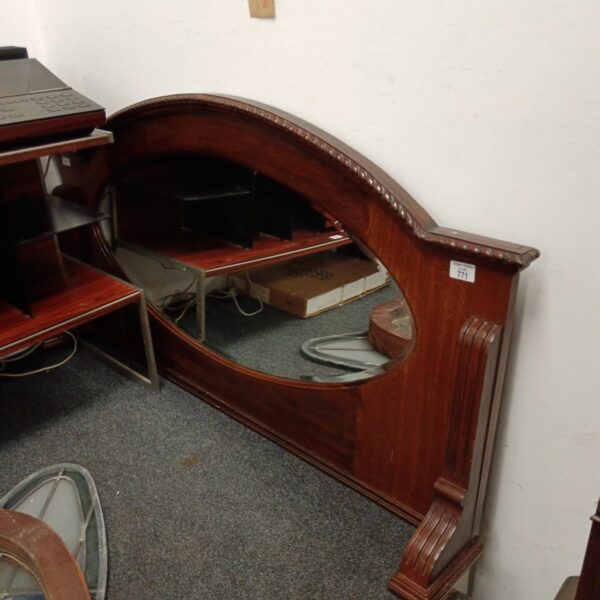 Large antique overmantle mirror with bevelled edge and detailed frame.