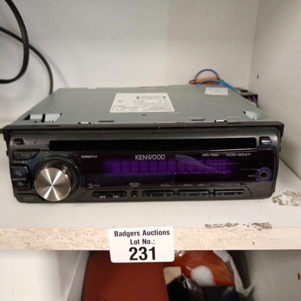 Kenwood KDC-3047 car stereo front panel with CD player.
