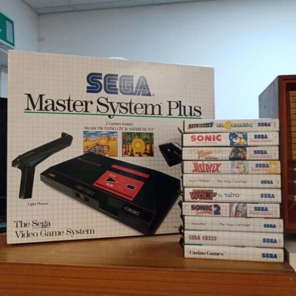 Boxed Sega Master System console with games, retro gaming collectible.