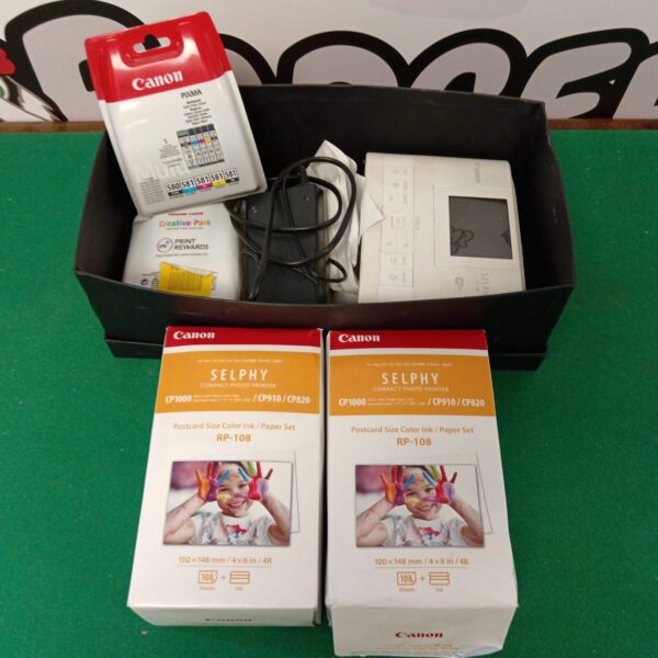 Canon Selphy CP1300 compact photo printer with packaging.