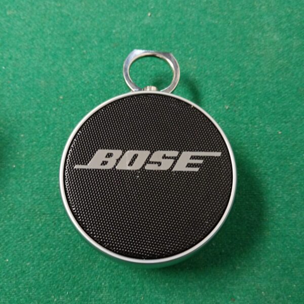 Front view of a circular Bose portable wireless speaker.