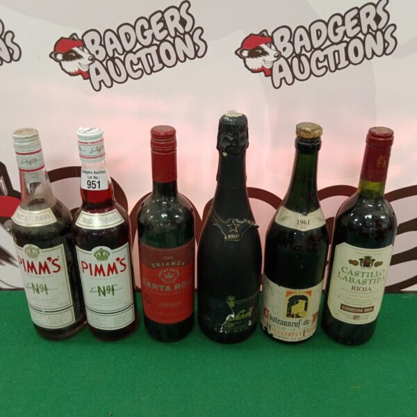 Mixed alcohol lot featuring Pimm's and Castillo Labastida Rioja bottles.
