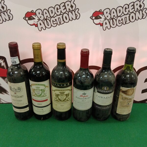 Wine lot featuring Chateau de la Garde Bordeaux and Haut-Nouchet bottles.