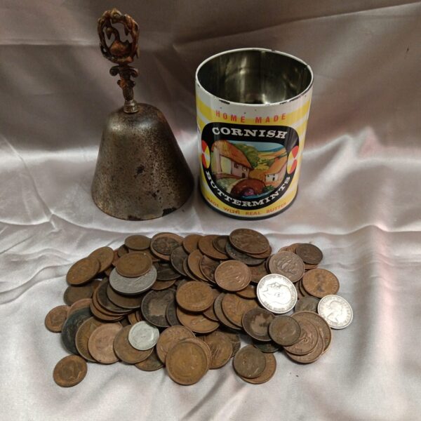 Vintage coin and hand bell lot in a tin.