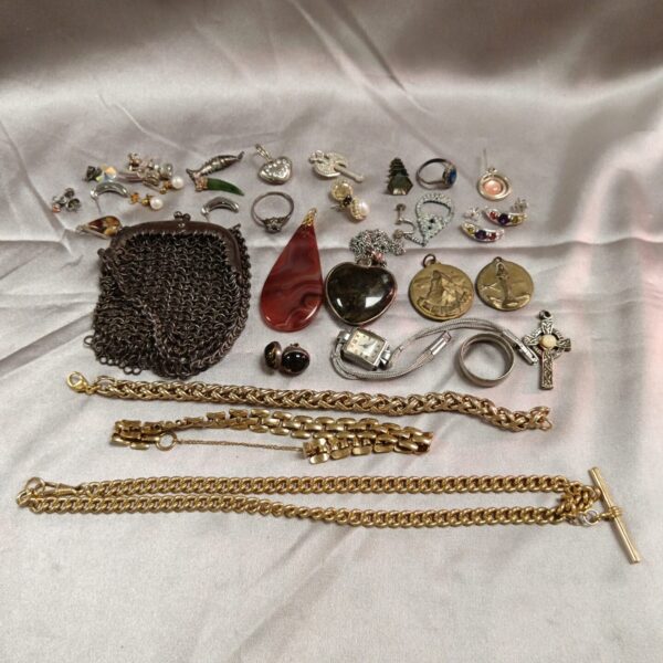 Assortment of vintage costume jewellery including necklaces and brooches.