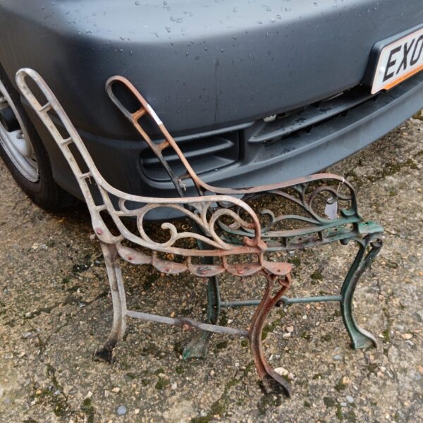 Antique wrought iron bench ends for garden restoration.