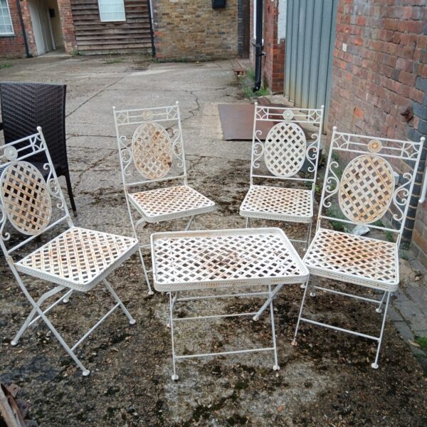 Vintage metal garden furniture set with table and four chairs.