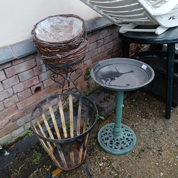 Garden ornament collection featuring fire basket and bird bath.