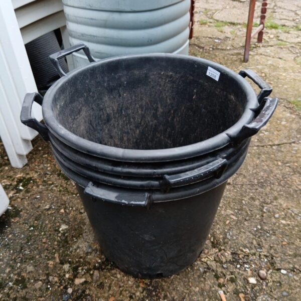 Large dark plastic garden plant pot with handles.