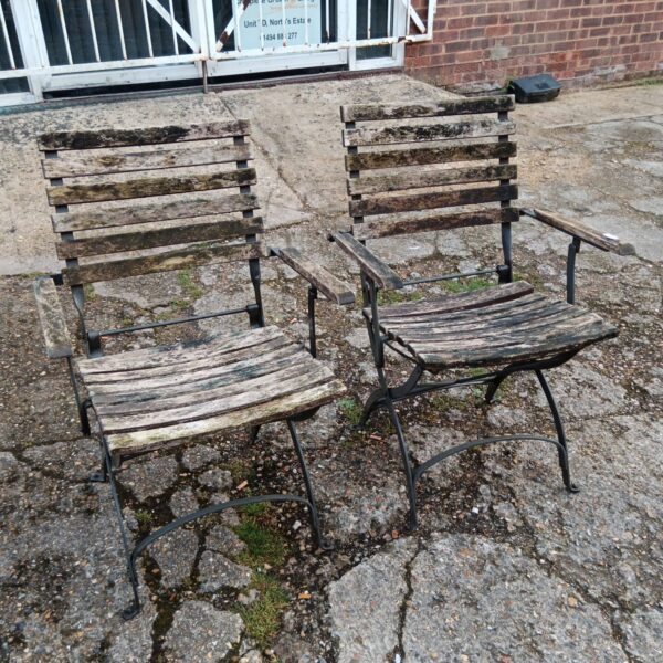 Pair of vintage metal garden chairs needing restoration.