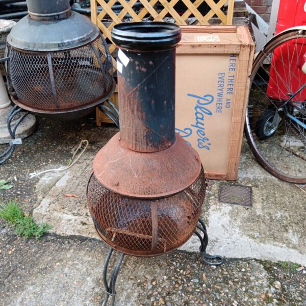 Vintage metal garden fire basket with weathered patina.