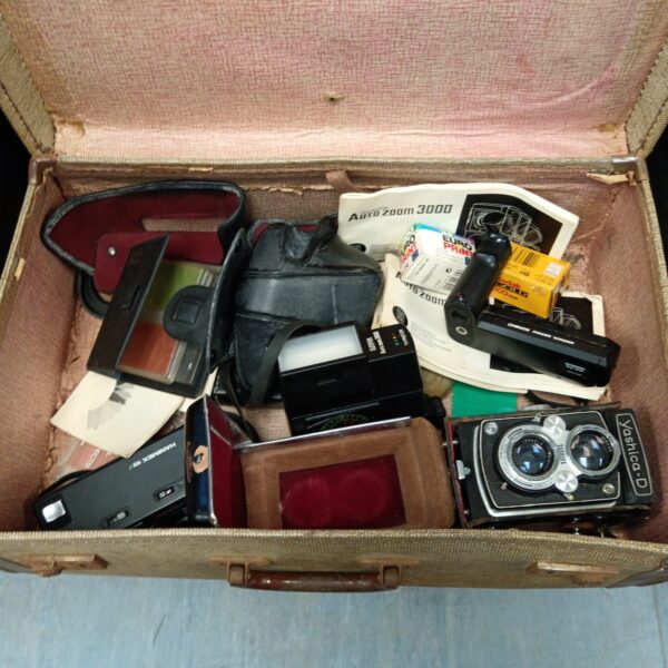 Vintage camera lot featuring a Yashica D and accessories.