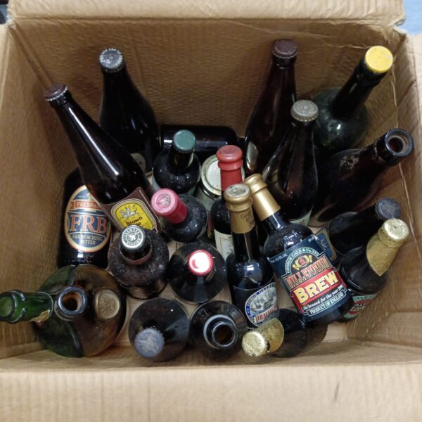 Collection of vintage beer bottles, showcasing antique brewery designs.