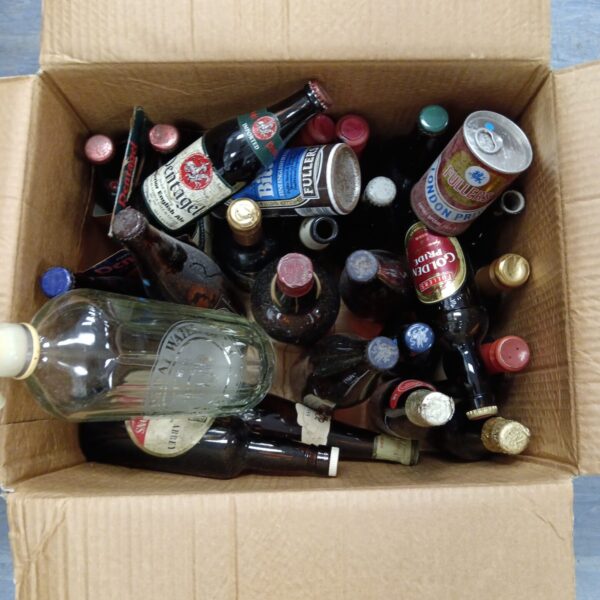 Vintage beer bottles collection, full and empty, brewery advertising.