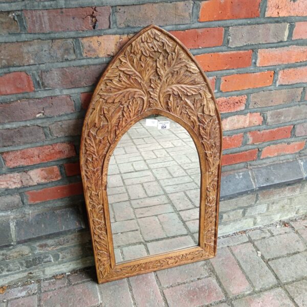 Antique gothic mirror with carved oak leaf detail.