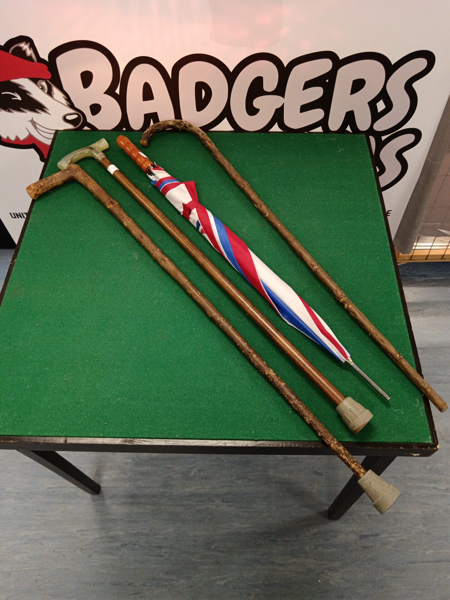 712 Bundle of three walking sticks & umbrella