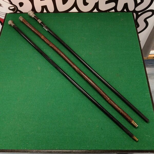 Lot of three vintage silver topped walking canes.