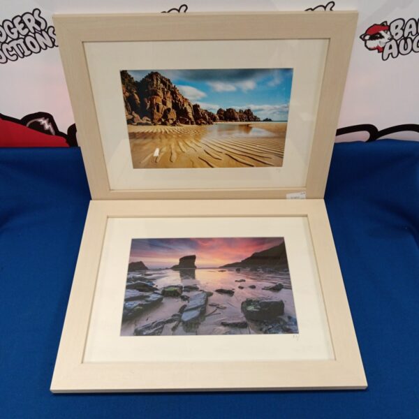 Framed coastal scene photograph depicting a sandy beach and blue sky.