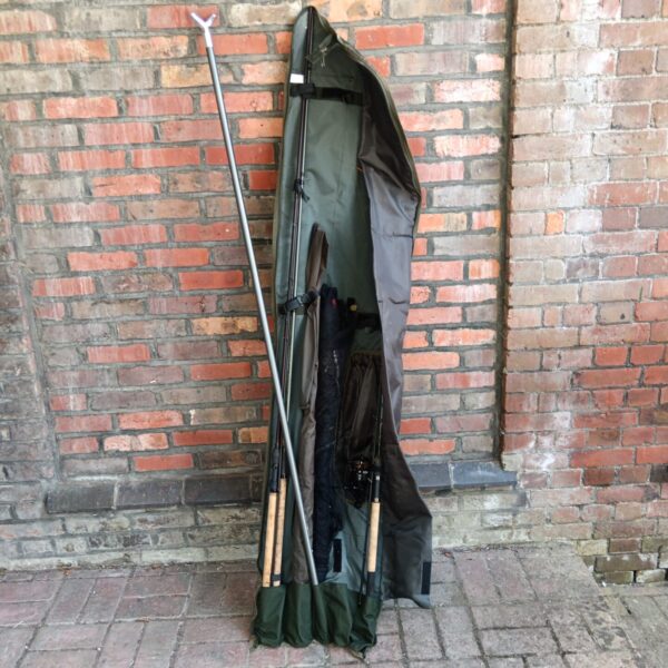 Green canvas fishing rod bag with angling equipment inside.