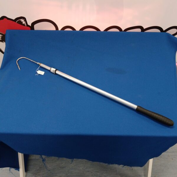 Long handled fishing gaf with metal hook for landing fish.