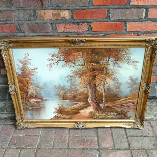 Vintage autumn woodland river painting by Caffieri in ornate gold frame.