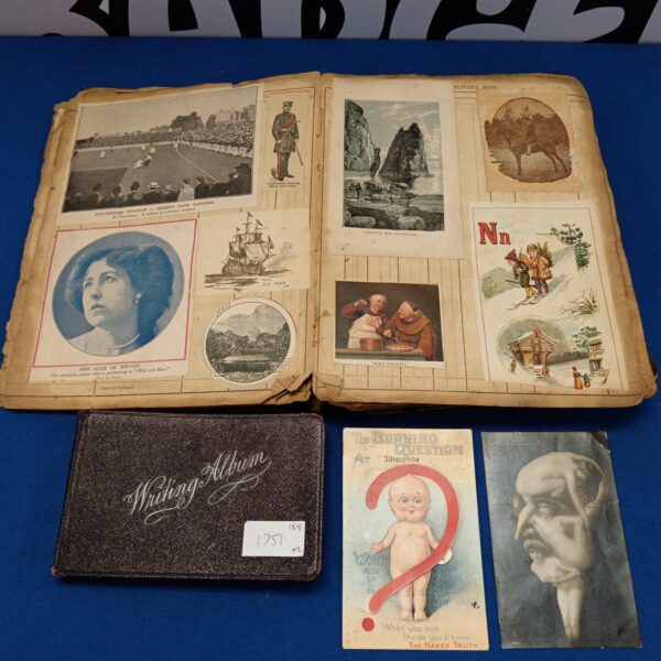 Open pages of a vintage Victorian scrapbook filled with ephemera.