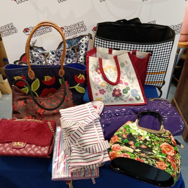 Assorted ladies handbags and bags in vibrant patterns.