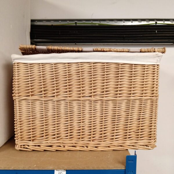 Large wicker laundry basket with woven texture.