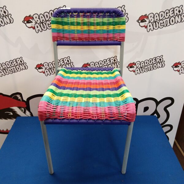 Vibrant rainbow coloured child's chair, side view.