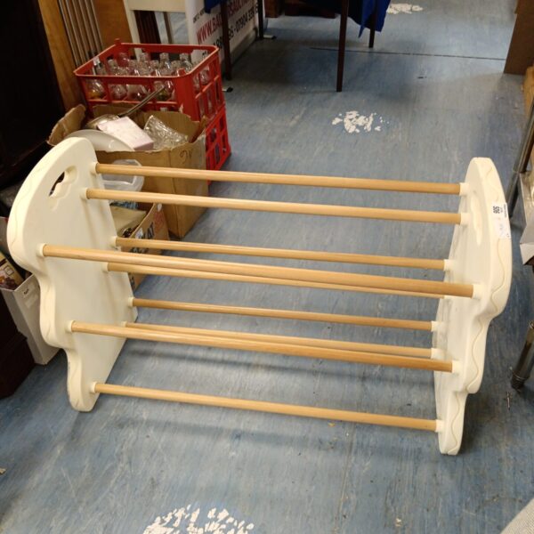 White three-tier shoe rack for hallway storage.