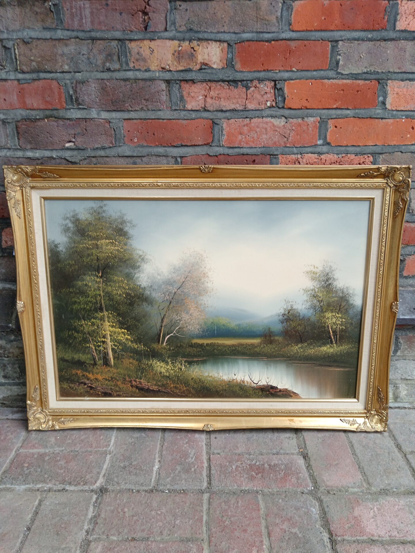 713 Gilt framed oil painting of a wooded lake landscape