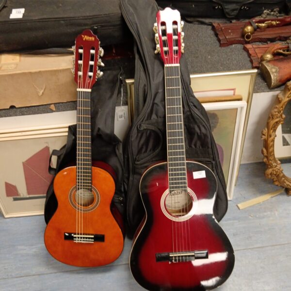 Ashton and Valencia acoustic guitars, a pair of musical instruments.