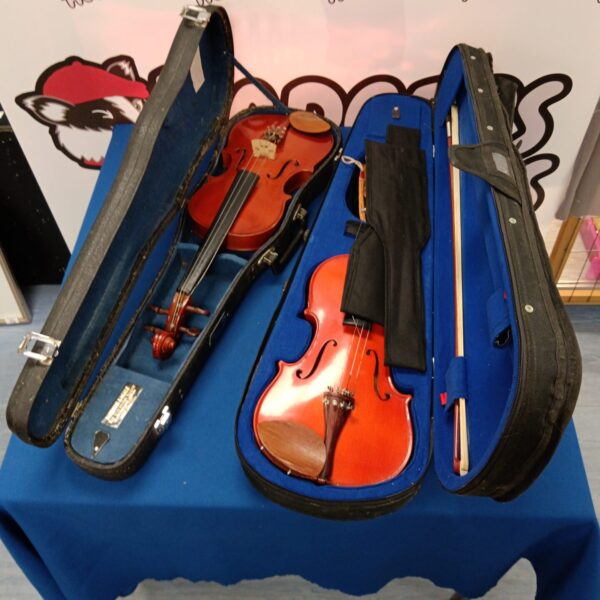 Two Stentor student violins inside a hard case with bows.