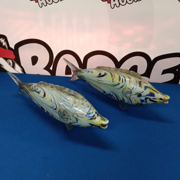Pair of vibrant Murano glass fish sculptures on display.
