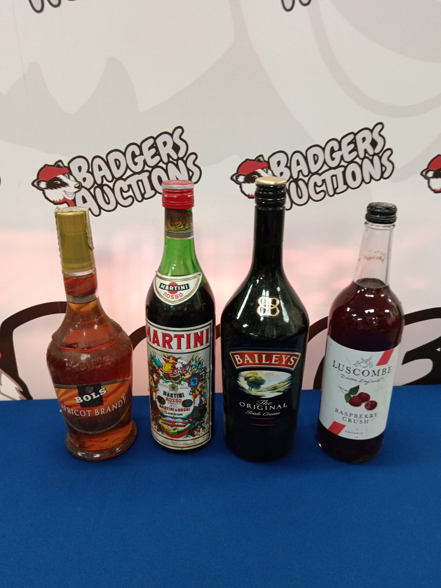 906 Four bottles of alcohol including martini & bowls apricot brandy