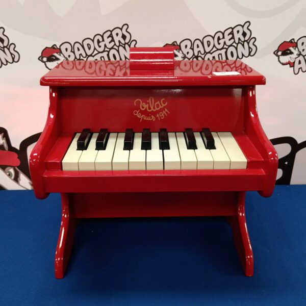Red Vilac child's piano with black and white keys.