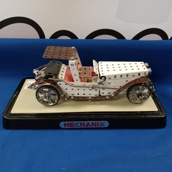 Vintage Meccano model car with exposed metal construction.