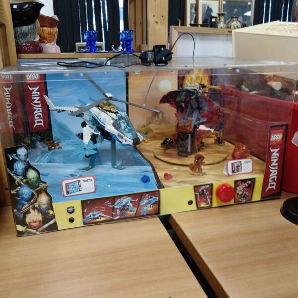 Lego Ninjago display case featuring sets 70673 and 70674.