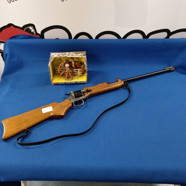 Vintage cap gun rifle with hand-painted details and Indian figurines.