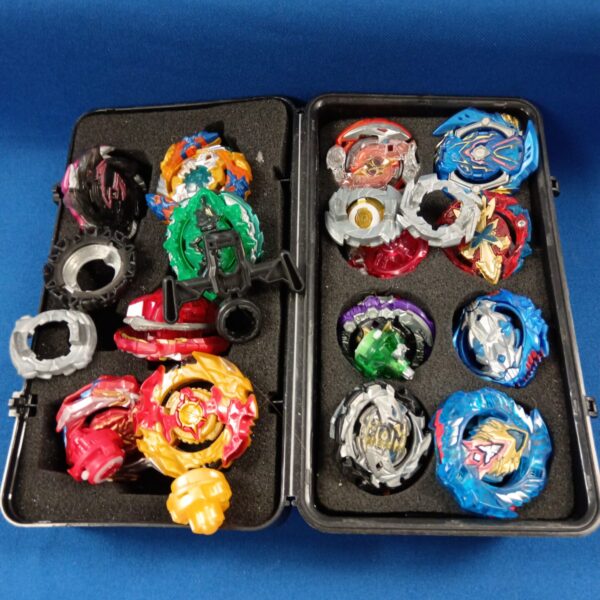 Assortment of Beyblade battle spinners in a storage case.
