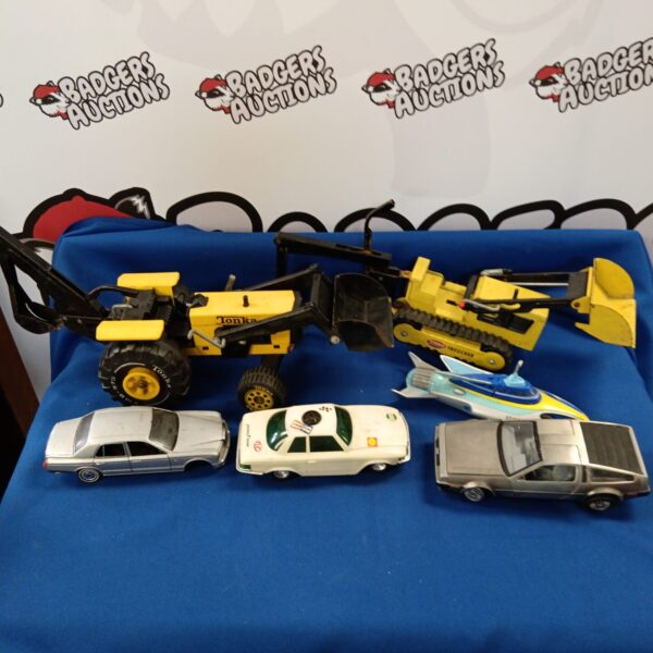 Vintage Tonka toy cars and diecast vehicle tray collection.