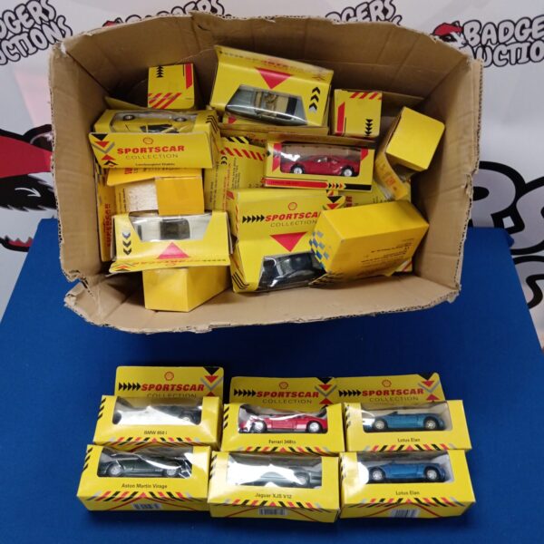 Vintage Shell diecast sports cars collection in a cardboard box.