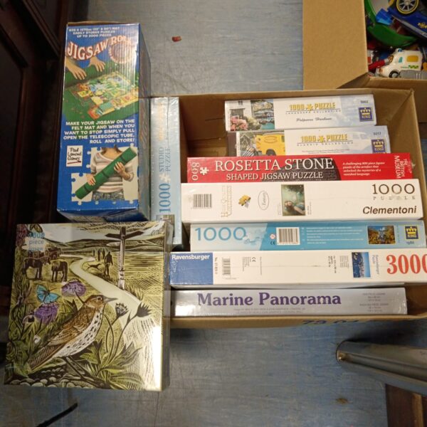 Sealed Clementoni jigsaw puzzles lot with roll mat for family fun.