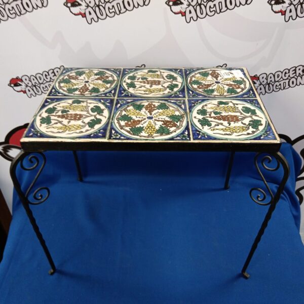 Vintage wrought iron table with floral ceramic tile top.