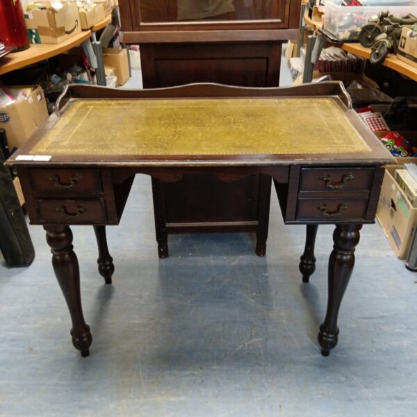 Antique green leather top desk with mahogany legs.