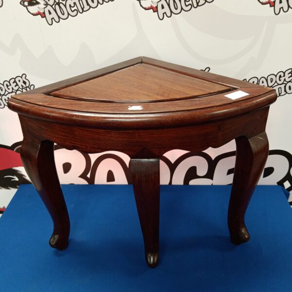 Vintage oak corner table with carved legs, ideal for small spaces.