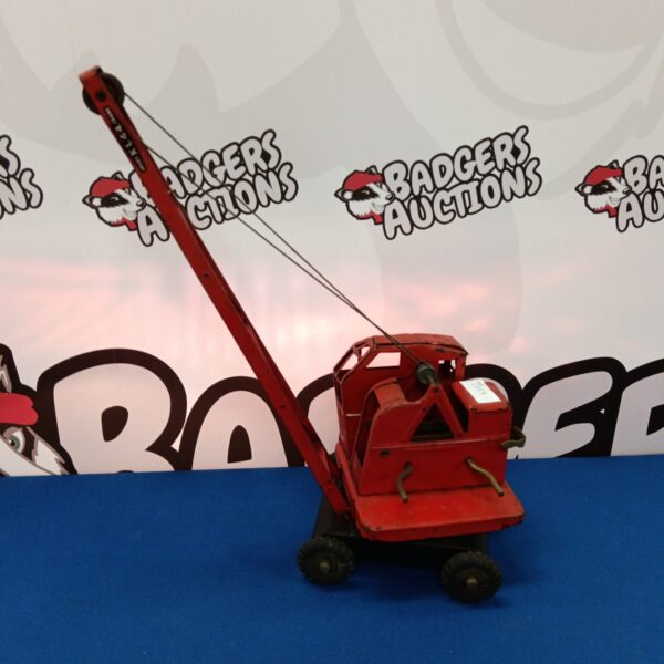 Red vintage Jones Kl44 toy crane with rotating boom.