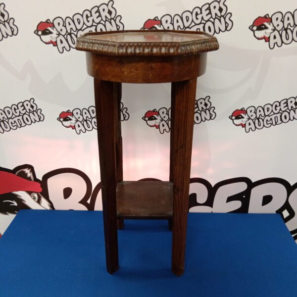 Vintage wooden jardiniere stand with curved legs.